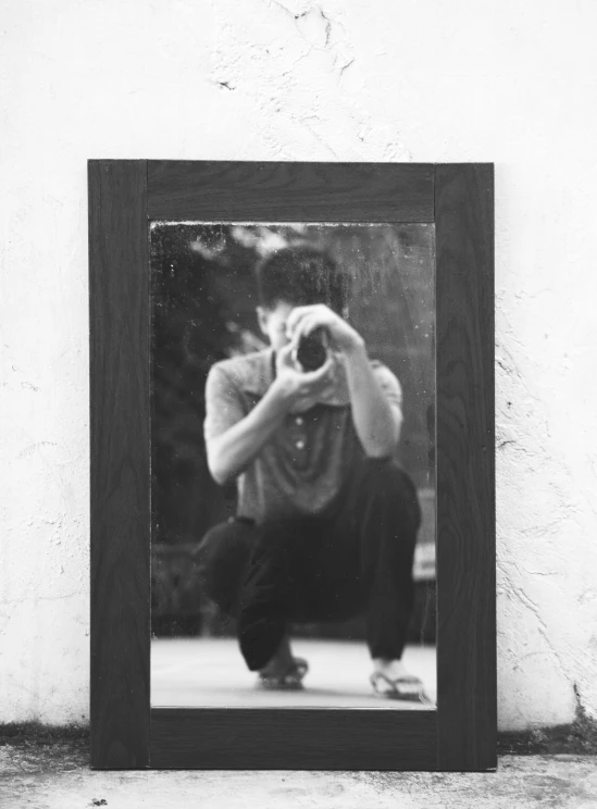 a man taking a picture of himself in a mirror, a black and white photo, realism, wooden frame, bruce lee, mirror texture, trending photo