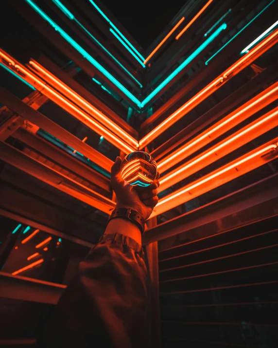 a person standing in front of neon lights, unsplash contest winner, striped orange and teal, red neon details, light from above, instagram post