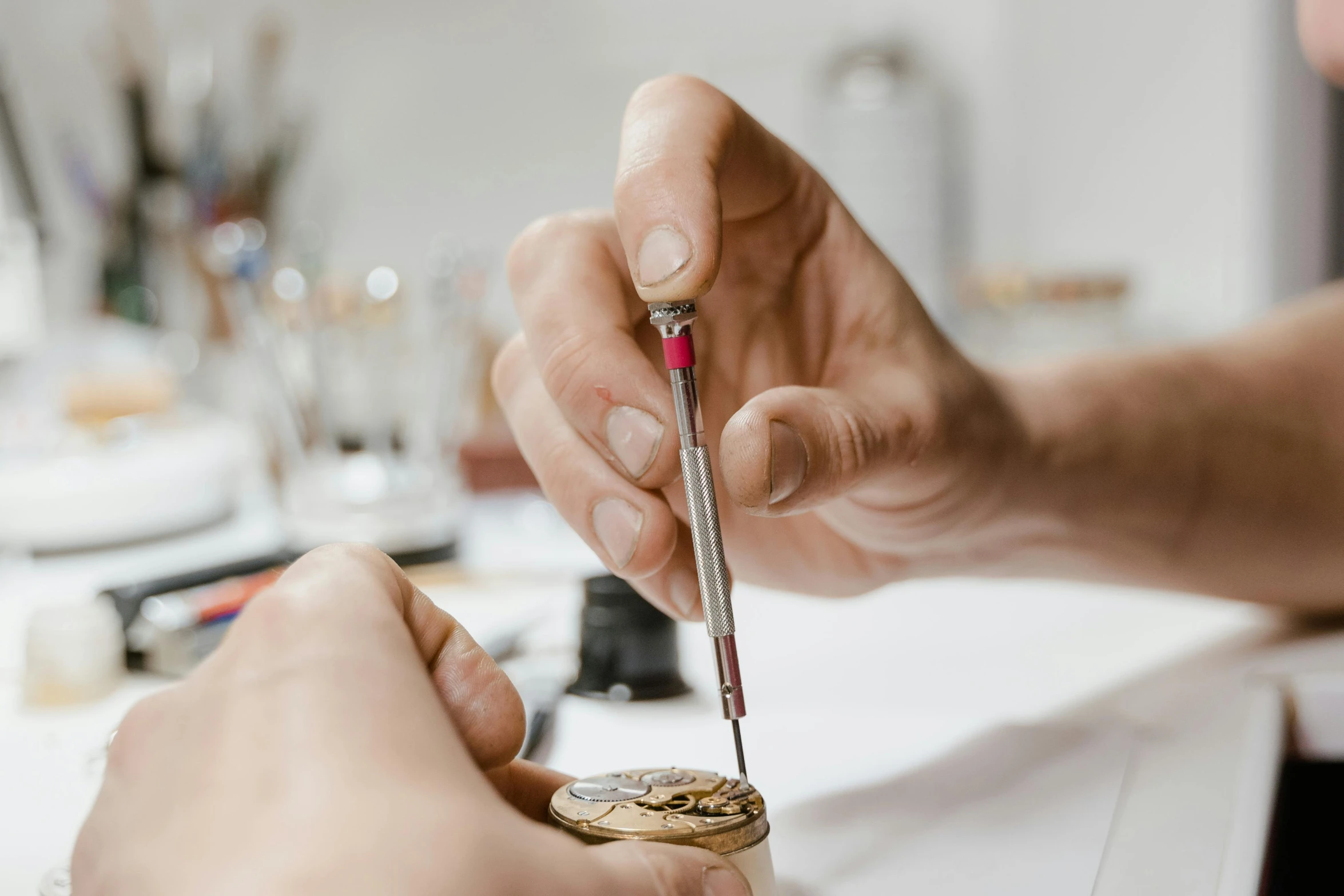 a close up of a person working on a watch, arbeitsrat für kunst, micro details, holding a scepter, platinum jewellery, pyrography