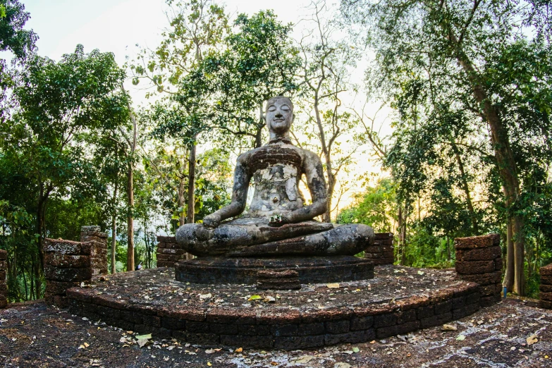 a statue sitting in the middle of a forest, sukhothai costume, avatar image