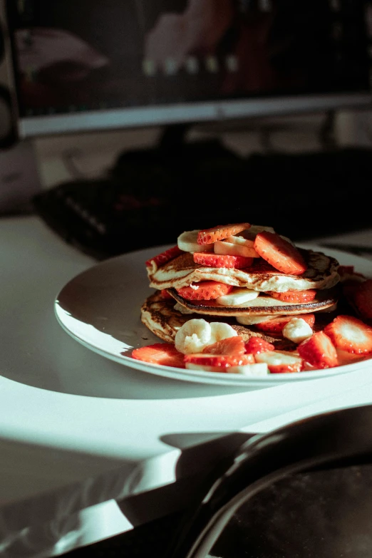 a stack of pancakes sitting on top of a white plate, by Adam Marczyński, pexels contest winner, strawberries, strong backlight, foil, at home