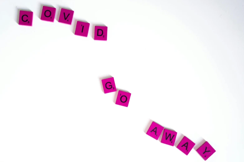 the word covid is spelled on a white surface, by Olivia Peguero, pexels, ((pink)), cubes, of letting go, awards