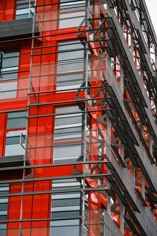 a red building with scaffolding in front of it, flickr, constructivism, closeup!!!!!, architecture award winner, coloured, modular