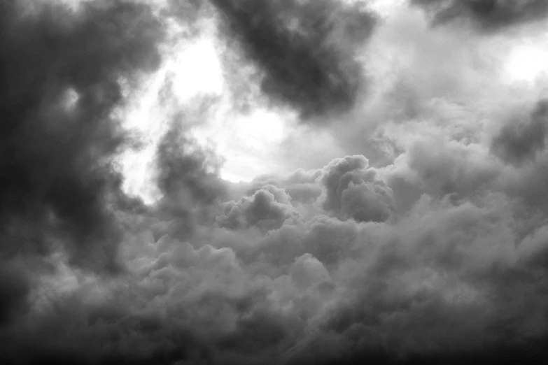 a black and white photo of a cloudy sky, by Mirko Rački, pexels, conceptual art, menacing!!!, heavenly clouds, a close-up, brooding