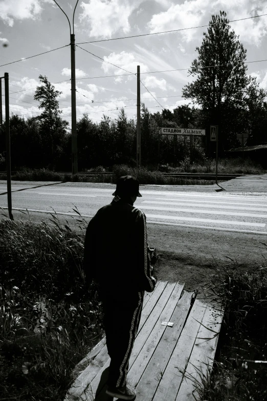 a black and white photo of a man on a skateboard, by Anato Finnstark, realism, abandoned bus stop, espoo, in the distance, 15081959 21121991 01012000 4k