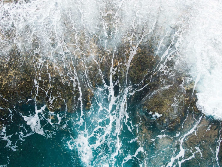 a person riding a surfboard on top of a wave, pexels contest winner, renaissance, waves crashing at rocks, aerial view top down, water particles, unsplash transparent fractal