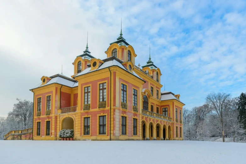 a large yellow building sitting on top of a snow covered field, rococo, beautiful surroundings, zdzislaw, highlight, thumbnail