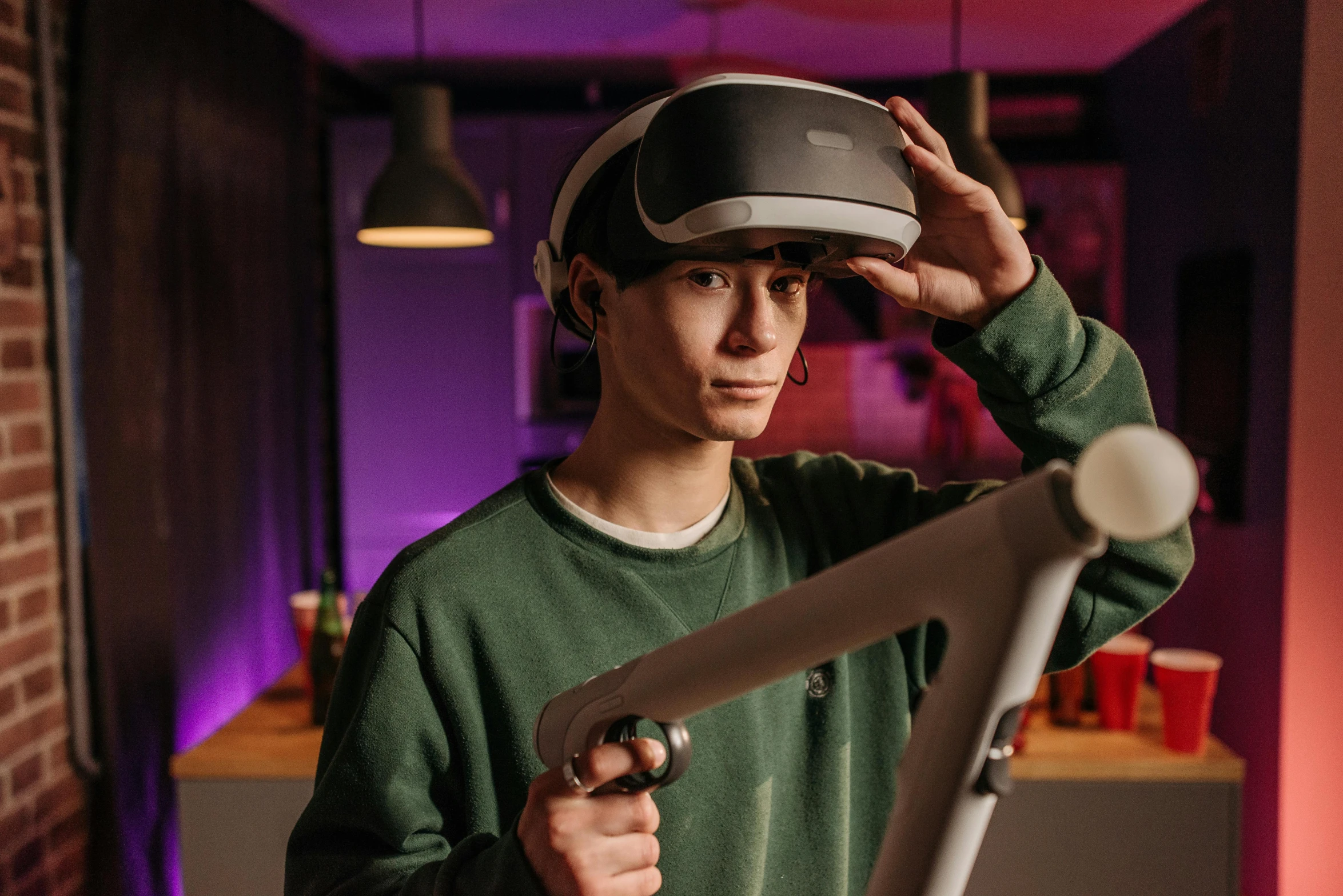 a man in a green shirt holding a baseball bat, a hologram, by Adam Marczyński, trending on pexels, interactive art, vr helmet, gaming room in 2 0 4 0, thin young male alchemist, julian ope