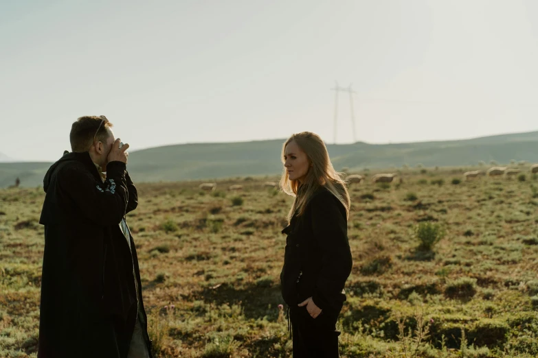 a man and a woman standing in a field, a picture, unsplash, happening, on set, billy butcher, alex heywood, julia hetta