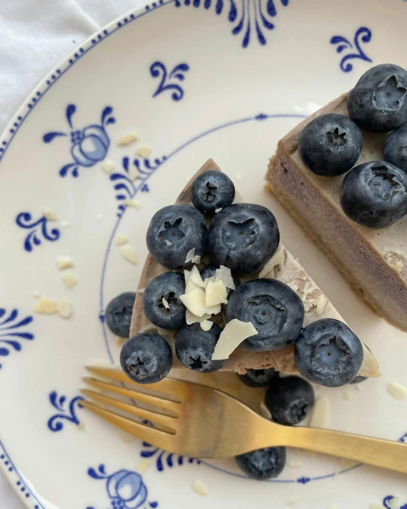 two pieces of blueberry cheesecake on a blue and white plate, by Helen Stevenson, product image, chocolate, thumbnail, healthy