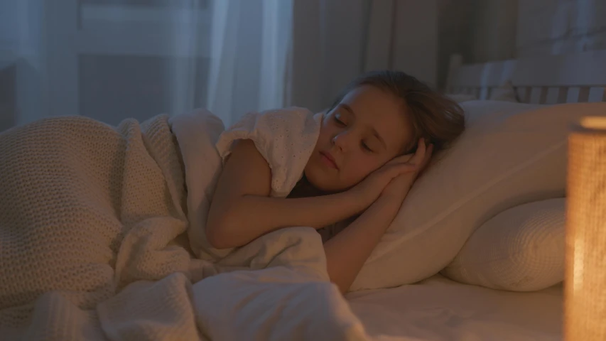 a little girl laying in bed under a blanket, inspired by Elsa Bleda, shutterstock, night light, soft lighting 8k, thumbnail, ( ( theatrical ) )