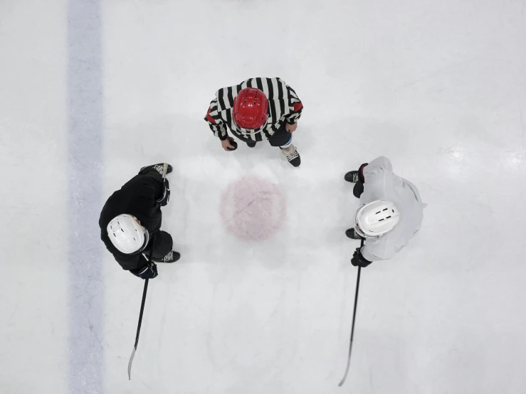 a group of people riding skis on top of a snow covered slope, game top down view, nhl, facing off in a duel, black and red only