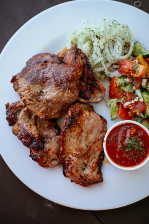 a white plate topped with meat and vegetables, salad, grills, caucasian, pork