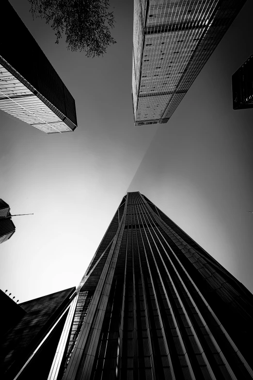 a black and white photo of tall buildings, by Tobias Stimmer, looking upwards, feng zhu |