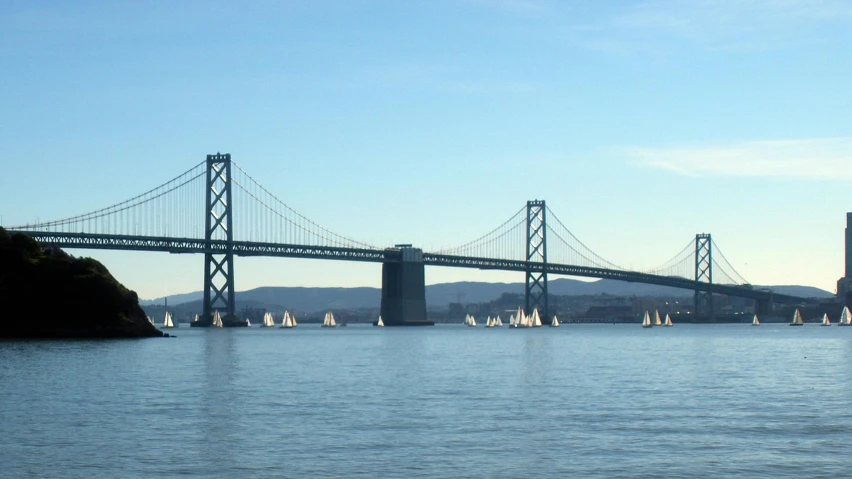 a body of water with a bridge in the background, a photo, sailboats soaring in the wind, bay area, slide show, ignant