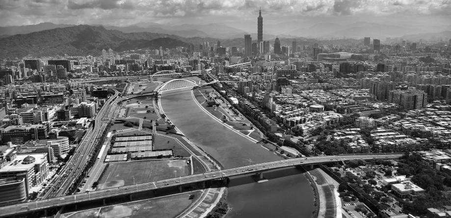 a black and white photo of a city, by Zha Shibiao, pexels contest winner, wide river and lake, taiwan, helicopter footage over city, andres gursky