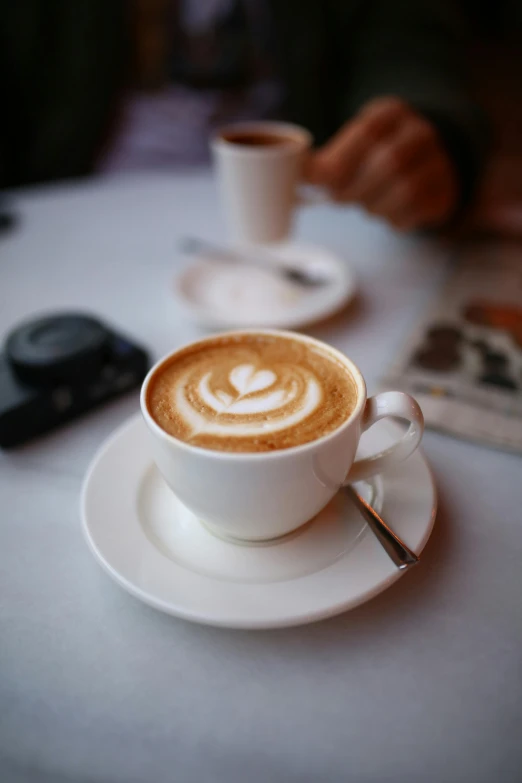 a couple of cups of coffee sitting on top of a table, by Jessie Algie, multiple stories, daily specials, thumbnail, ground level shot