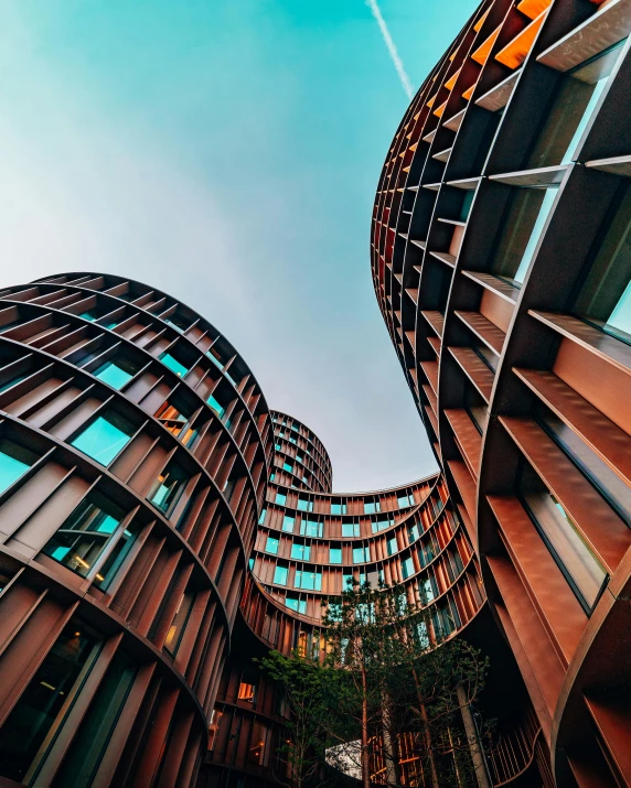 a couple of buildings that are next to each other, an abstract sculpture, unsplash contest winner, curves, instagram picture, huge towering magical university, worms eye view
