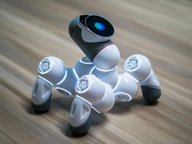 a small robot sitting on top of a wooden floor, six arms, futuristic product design, robot dog, curvy build