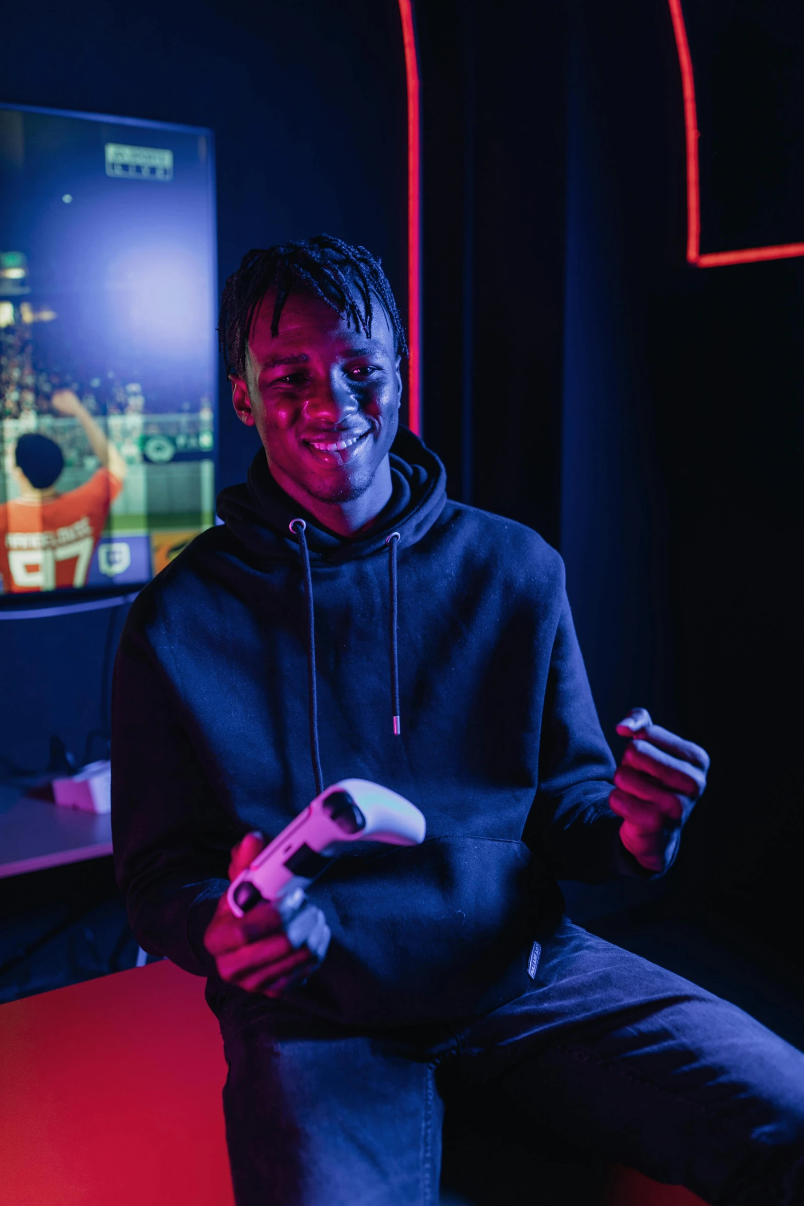 a man sitting in front of a tv playing a video game, pexels contest winner, playboi carti portrait, standing in a starbase bar, holding controller, ( ( dark skin ) )