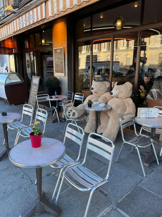 a teddy bear sitting on a table outside of a restaurant, trending on reddit, maurizio cattelan, thumbnail, low quality photo, sitting on a mocha-colored table