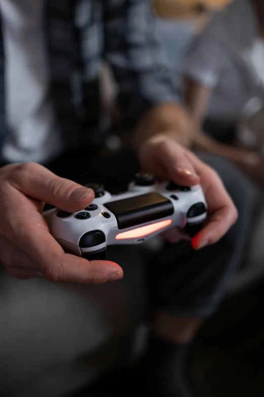 a close up of a person holding a video game controller, thumbnail, ps