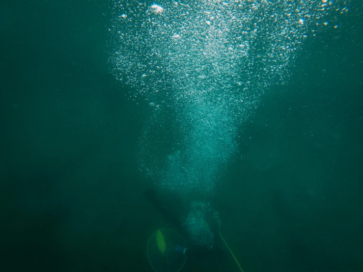 a person that is swimming in the water, by Jay Hambidge, unsplash, very deep sea, lots of bubbles, dredged seabed, fishing