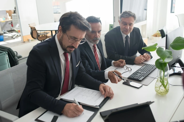 a group of men sitting at a table working on laptops, pexels contest winner, renaissance, wearing a suit and glasses, signing a bill, expert design, rule of three