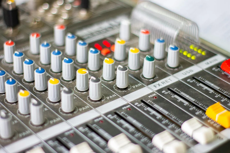 a close up of a mixing board with many knobs, pexels, process art, radio signals, table with microphones, coloured, tannoy