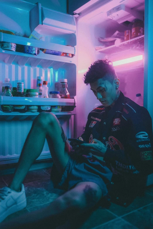 a man sitting in front of an open refrigerator, inspired by Liam Wong, pexels contest winner, lil peep, bisexual lighting, declan mckenna, looking at his phone