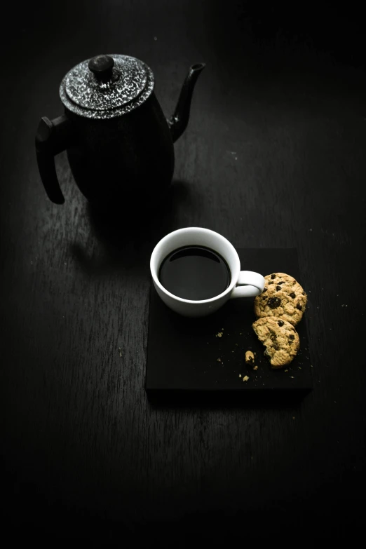 a cup of coffee and a cookie on a table, by Daniel Seghers, pexels contest winner, black on black, 15081959 21121991 01012000 4k, medium portrait, back