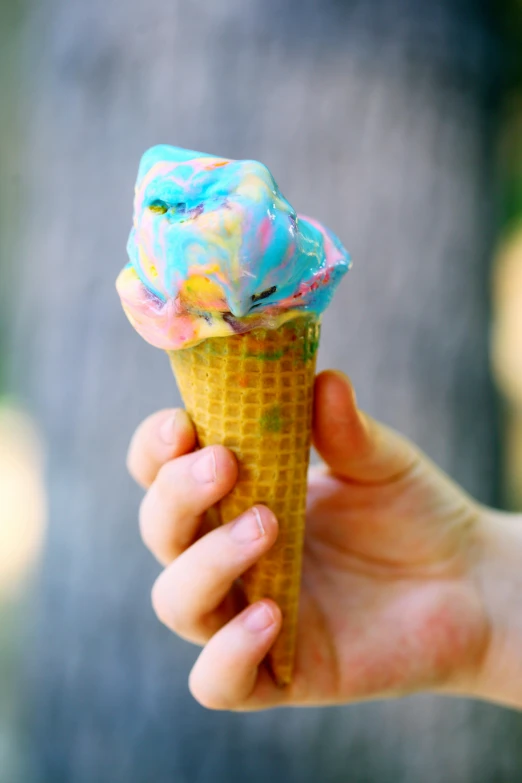 a person holding an ice cream cone in their hand, colourful slime, blue, al fresco, battered