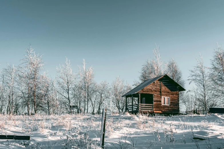 a small cabin sitting on top of a snow covered field, pexels contest winner, thumbnail, southern slav features, various posed, brightly lit