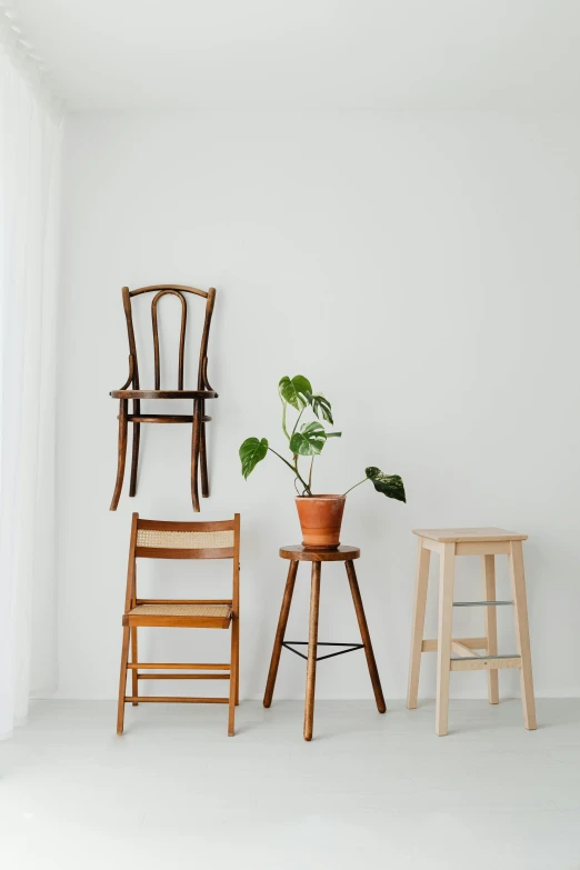 three chairs and a table in a white room, inspired by Constantin Hansen, trending on unsplash, portrait of tall, standing on a shelf, japanese collection product, shot on sony a 7