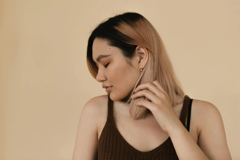 a woman holding a cell phone to her ear, a character portrait, inspired by Ruth Jên, trending on pexels, realism, brown tones, photoshoot for skincare brand, thin wires, angle profile portrait