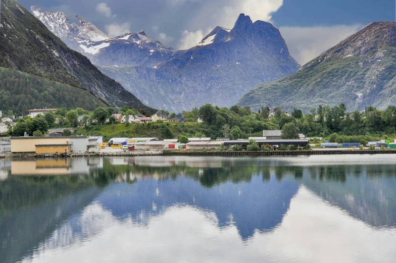 a body of water with mountains in the background, a picture, inspired by Nikolai Astrup, pexels contest winner, hurufiyya, small port village, beautiful reflexions, harbor, istockphoto