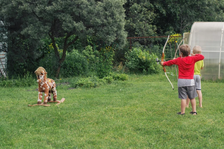 a little boy that is standing in the grass with a bow, pexels contest winner, renaissance, animals chasing, traditional corsican, archery, panoramic shot