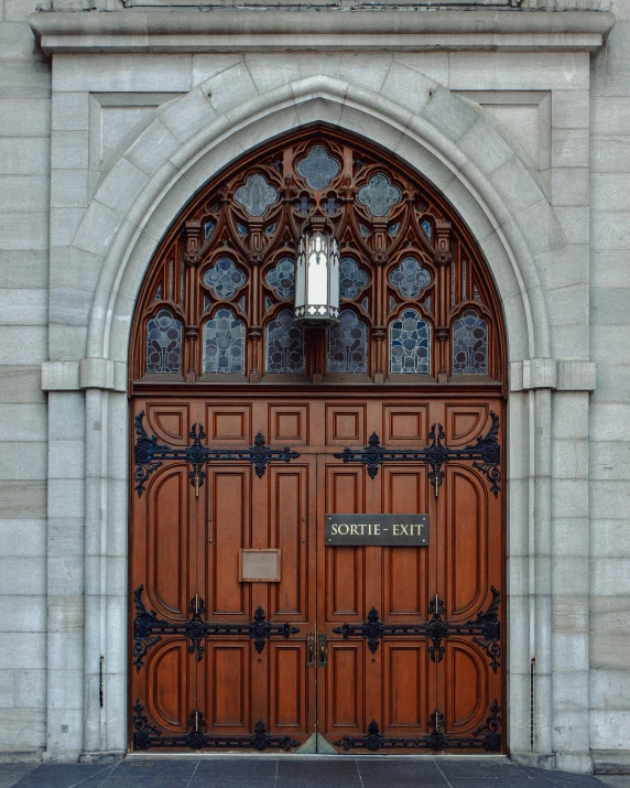 a red fire hydrant sitting in front of a wooden door, by Jacob Burck, pexels contest winner, romanesque, gothic arch frame, the narthex, lgbt, cornell