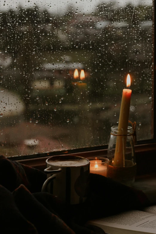 a candle that is sitting on a window sill, inspired by Elsa Bleda, unsplash contest winner, rainy scene, sitting in a cafe alone, in a storm, candlelight