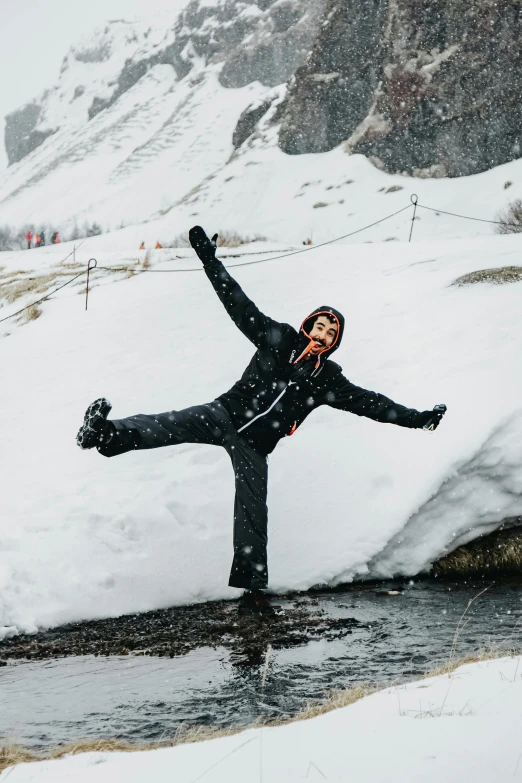 a man that is standing in the snow, an album cover, pexels contest winner, figuration libre, doing a sassy pose, dolomites, she expressing joy, acrobatic pose