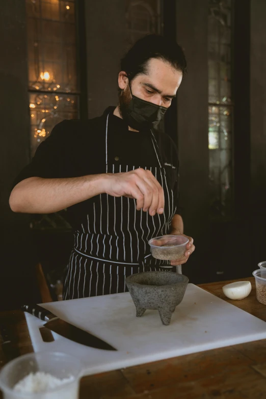 a man in an apron preparing food on a cutting board, a portrait, inspired by Hendrik Gerritsz Pot, pexels contest winner, vantablack gi, clay model, chilean, profile image