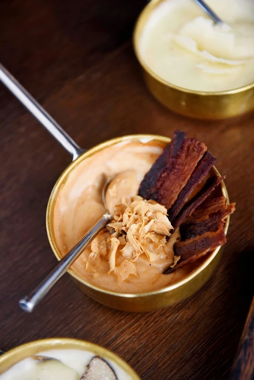 a close up of a bowl of food on a table, inspired by Reuben Tam, copper, mayonnaise, chewing tobacco, blonde