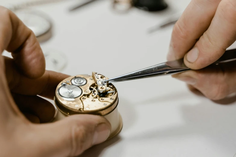 a close up of a person working on a watch, an etching, trending on pexels, van cleef & arpels, thumbnail, partially operational, quick assembly