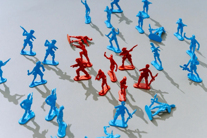 a group of toy soldiers standing in a circle, a cartoon, by David Donaldson, pexels, plasticien, blue and red, zombies attack, on grey background, orange and cyan paint decals