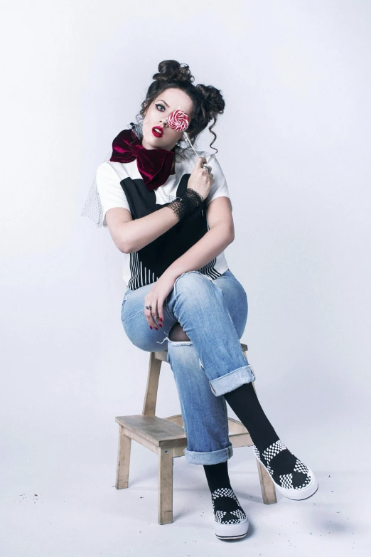 a woman sitting on top of a wooden chair, dressed in crustpunk clothing, overalls, holding a pudica pose, profile image