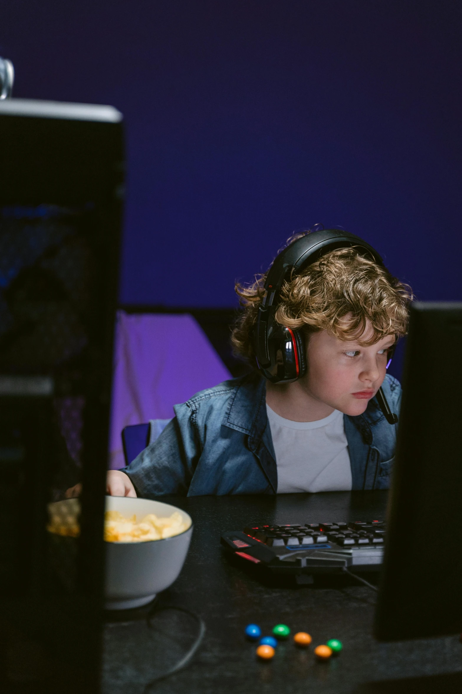 a young boy sitting at a table in front of a computer, streaming on twitch, game ready, promo image, colour corrected