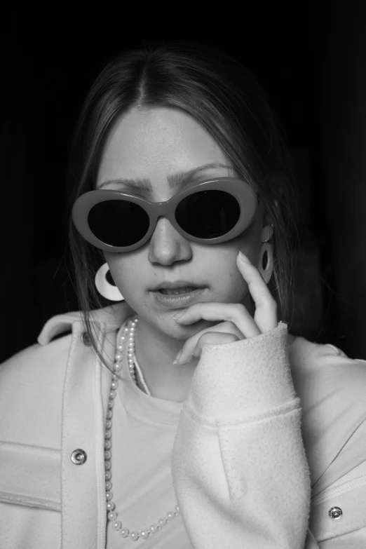 a black and white photo of a woman wearing sunglasses, a black and white photo, inspired by Maud Naftel, trending on pexels, sydney sweeney, discord profile picture, bad bunny, an all white human