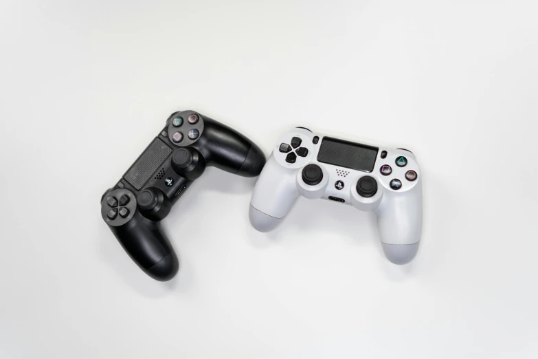 a couple of video game controllers sitting next to each other, minimalism, white and silver, taken with sony alpha 9, dueling, jenna barton