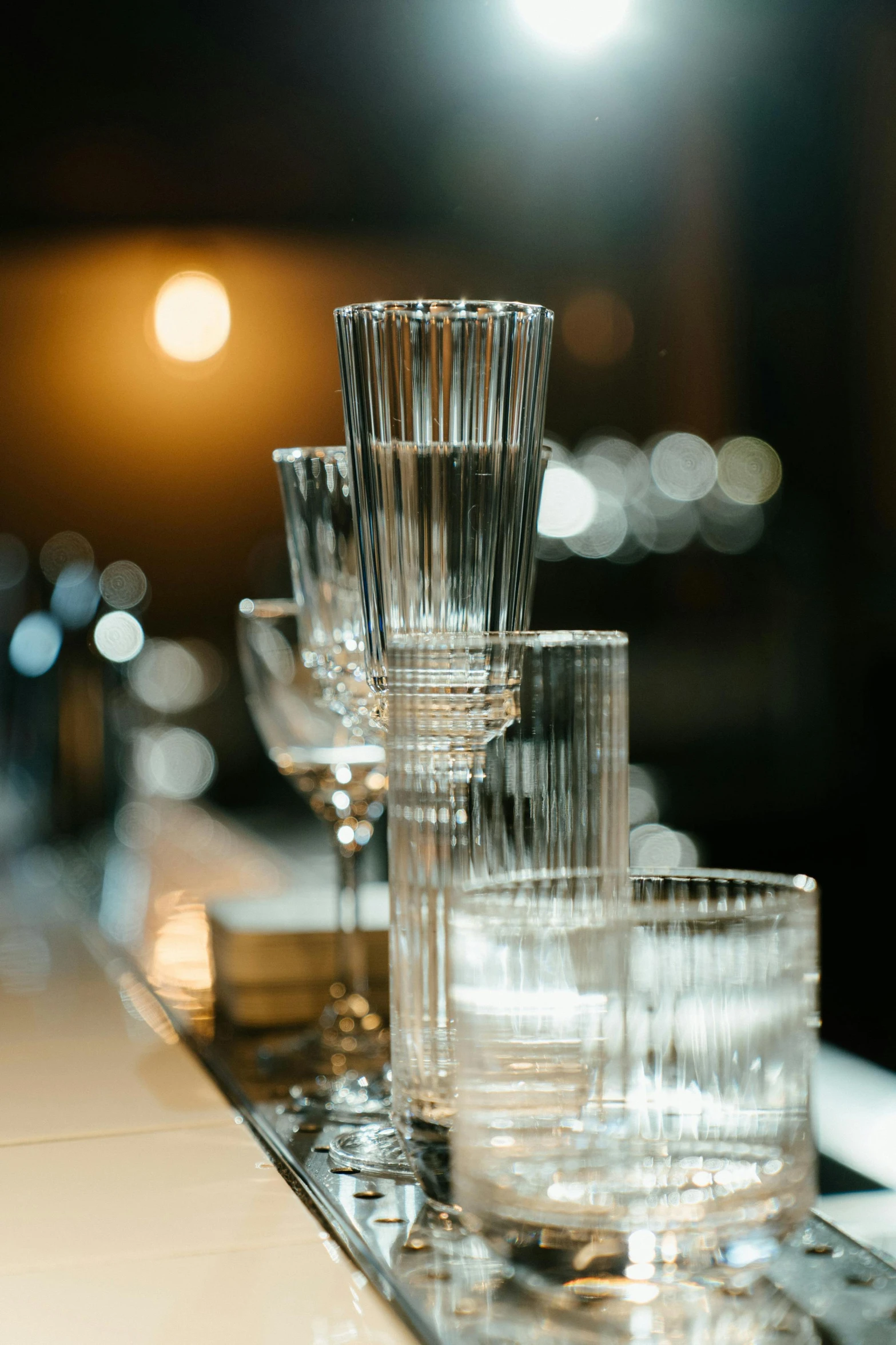 a row of glasses sitting on top of a counter, renaissance, crystal clear, uplit, glassware, extra details