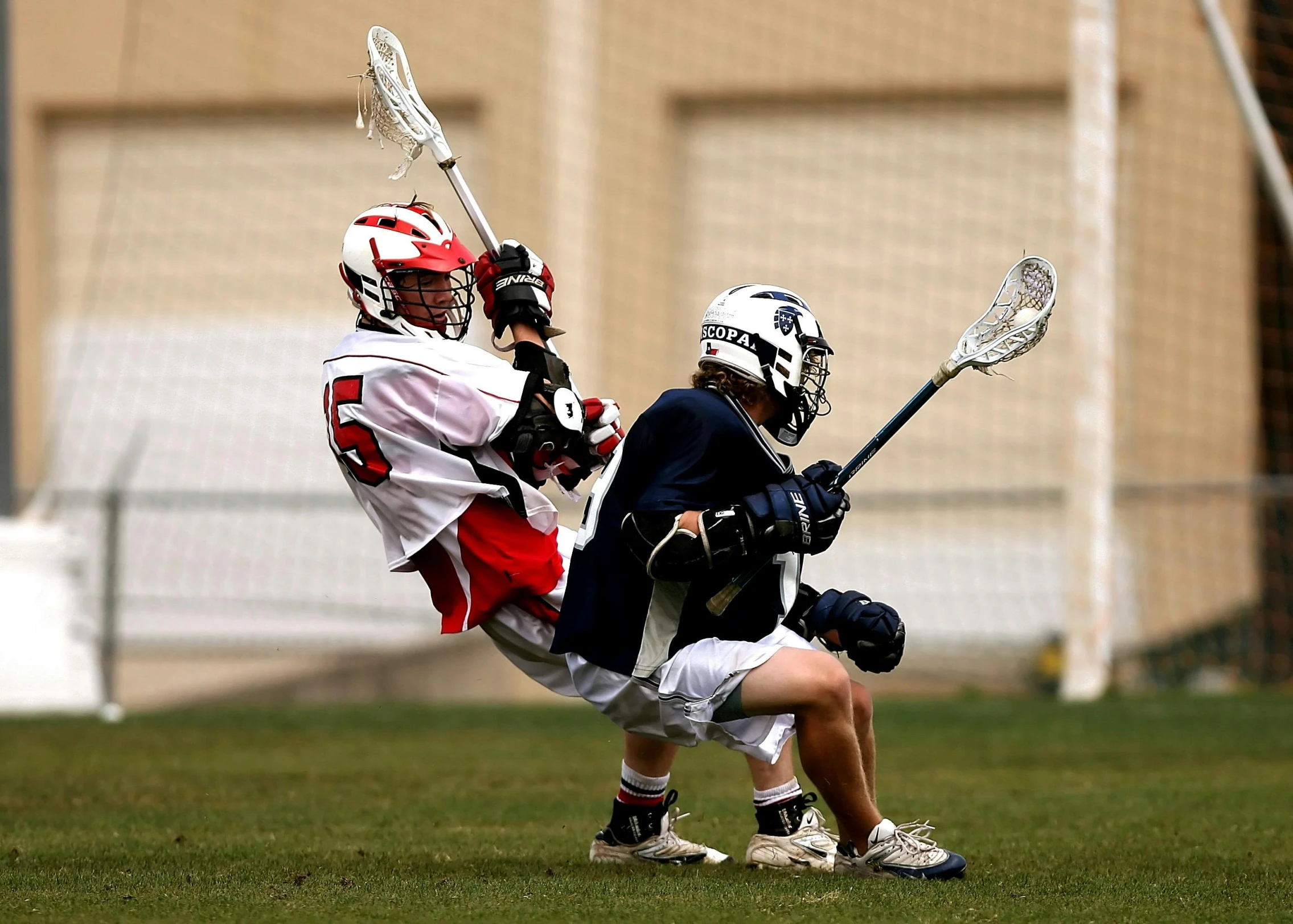 a couple of men playing a game of lacrosse, by Paul Davis, shutterstock, high-speed sports photography, shot on nikon d 3 2 0 0, helmet, little kid